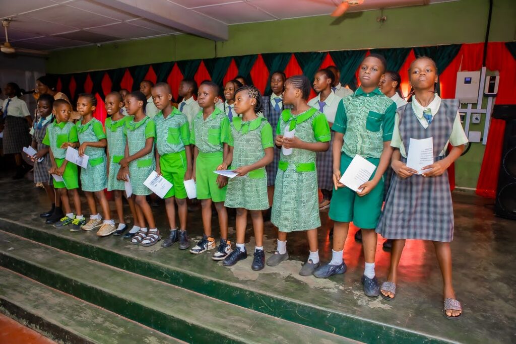Primary pupils in Cityside uniform singing at an event